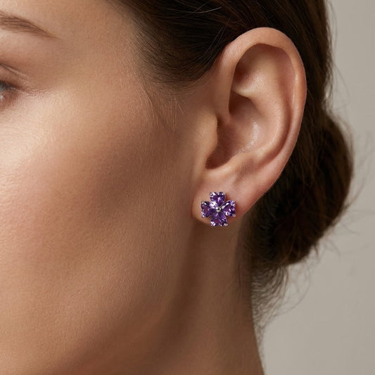 Amethyst flower stud earrings worn on ear close-up