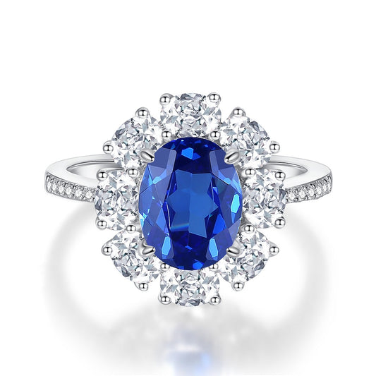 Royal Blue Sapphire Oval Halo Ring on white background