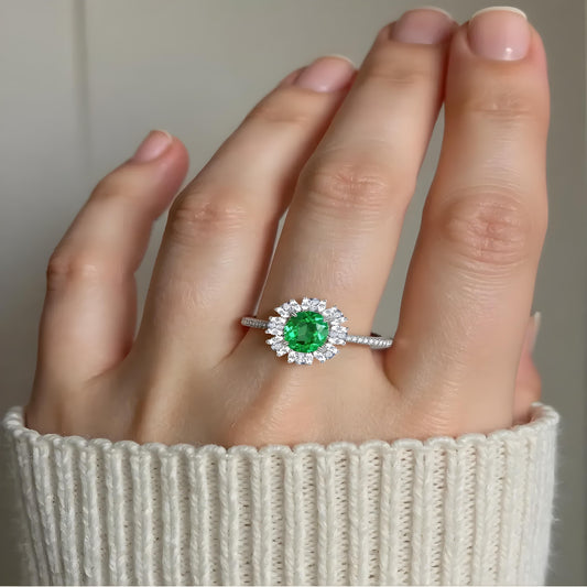 Model wearing Aeterna Jewelry Paraiba tourmaline halo ring, radiating fresh green glow on hand