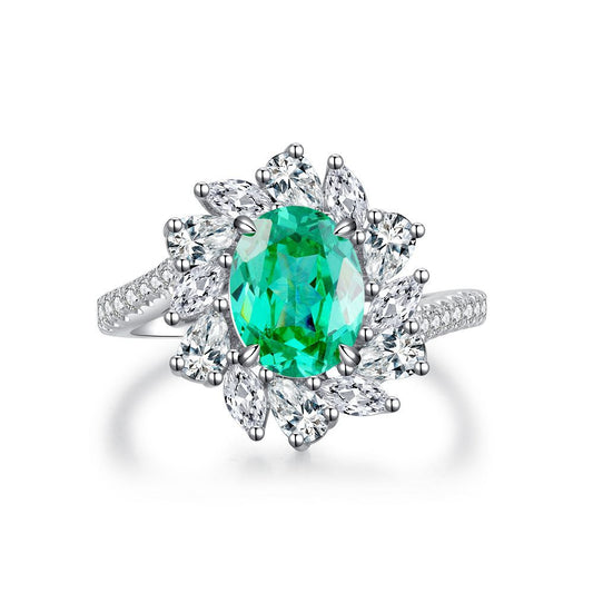 Oval Emerald Flower Halo Ring on white background