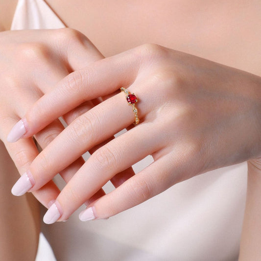 Woman wearing a gold vermeil garnet birthstone ring with a delicate red gemstone