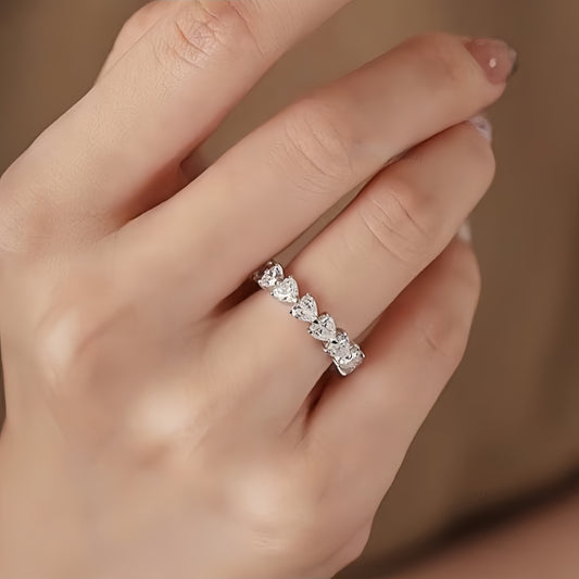 Model wearing Aeterna Jewelry triangle-cut eternity ring, showing sparkling brilliance and elegant feminine style