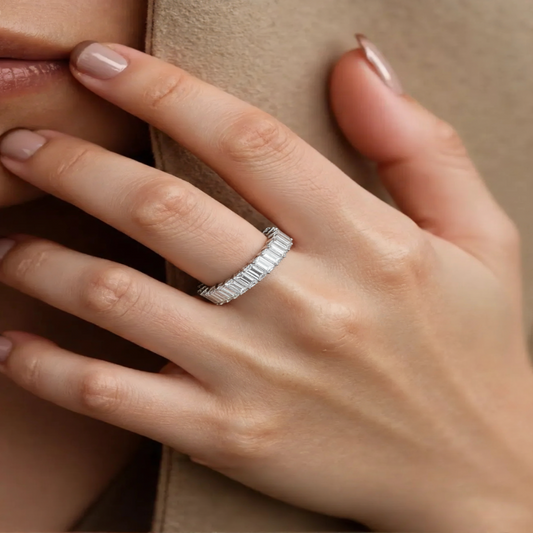 Model wearing Aeterna Jewelry baguette-cut eternity ring on hand, showing elegant brilliance and refined sparkle