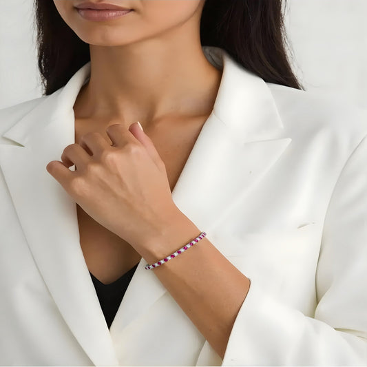 Model wearing ruby and white gemstone tennis bracelet by Aeterna Jewelry