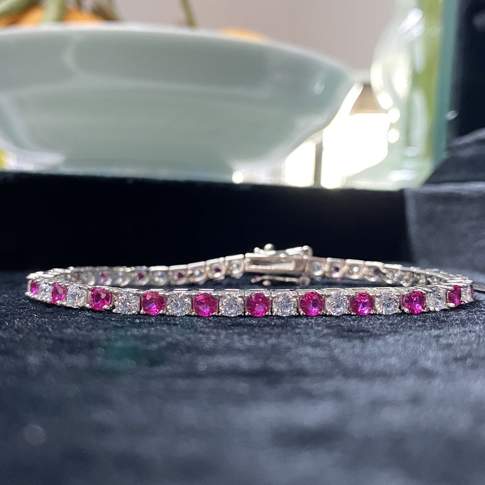 Aeterna Jewelry ruby and white alternating tennis bracelet on black velvet background