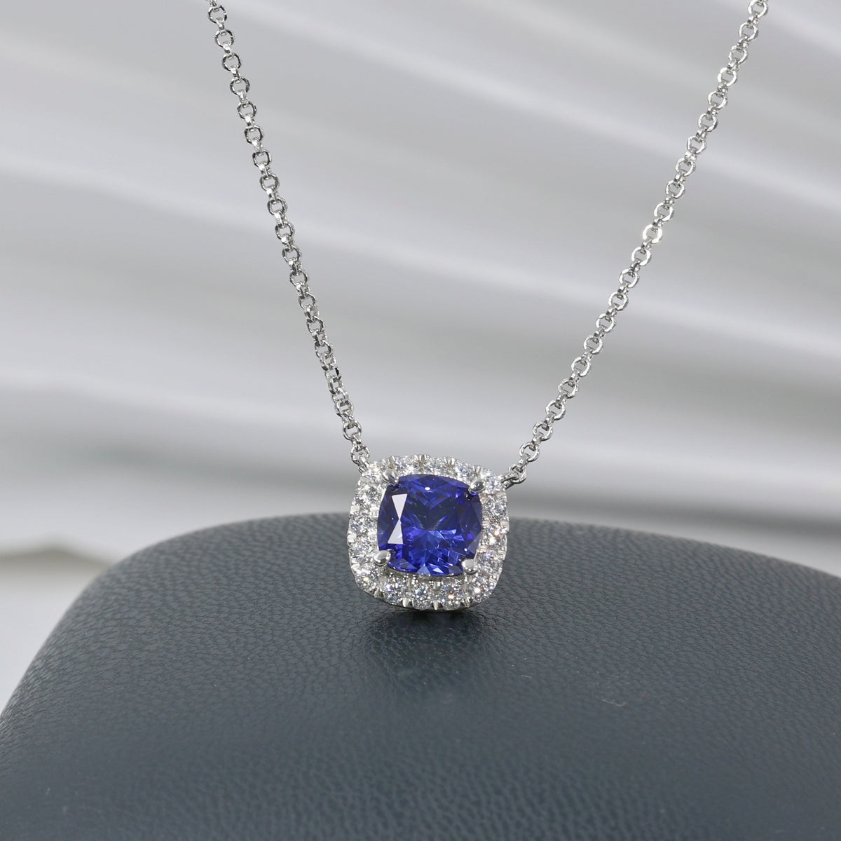 1.9ct Blue Sapphire Halo Pendant Necklace on white background