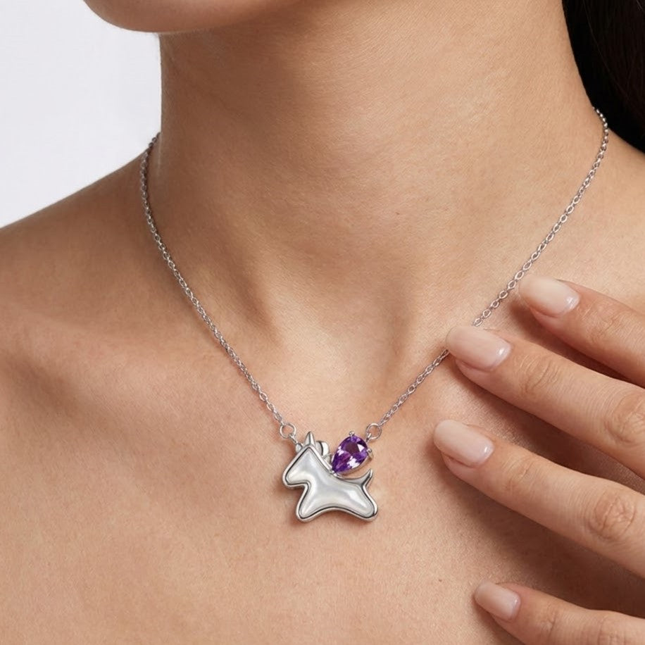 Model wearing amethyst unicorn pendant necklace on neckline