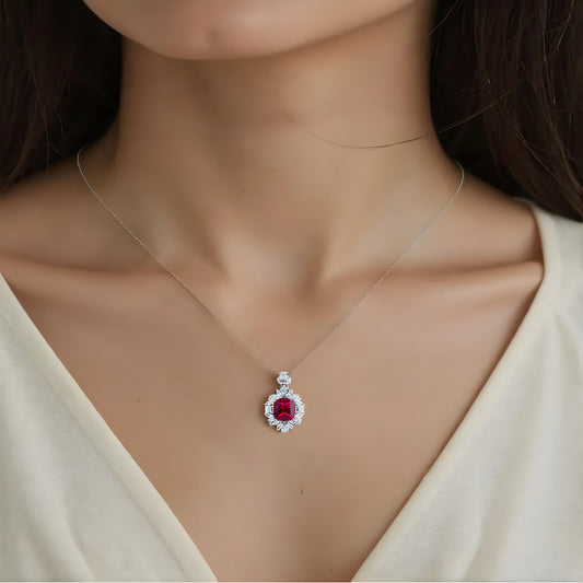 Aeterna Jewelry red ruby pendant necklace worn on model’s neckline