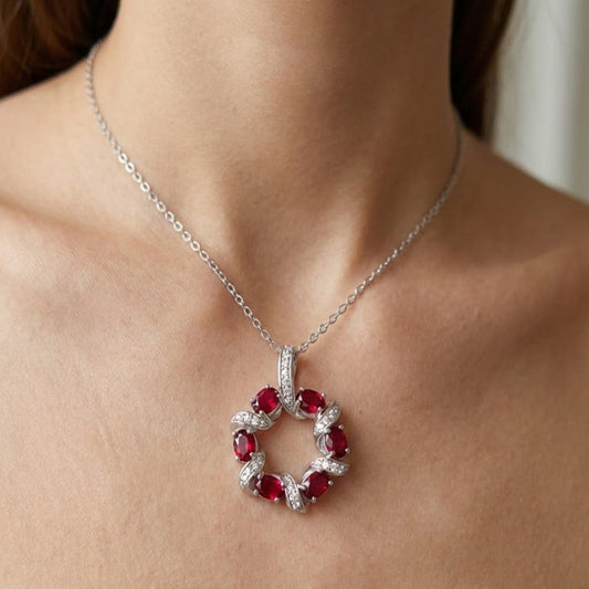 Model wearing a garnet birthstone circle pendant necklace in sterling silver