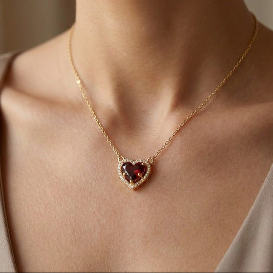 Heart-shaped garnet birthstone necklace worn on model, gold-plated sterling silver jewellery