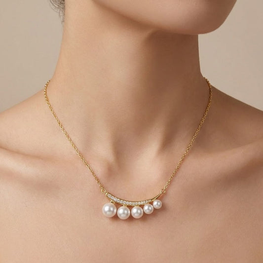 Gold pearl bar necklace worn on neck close-up