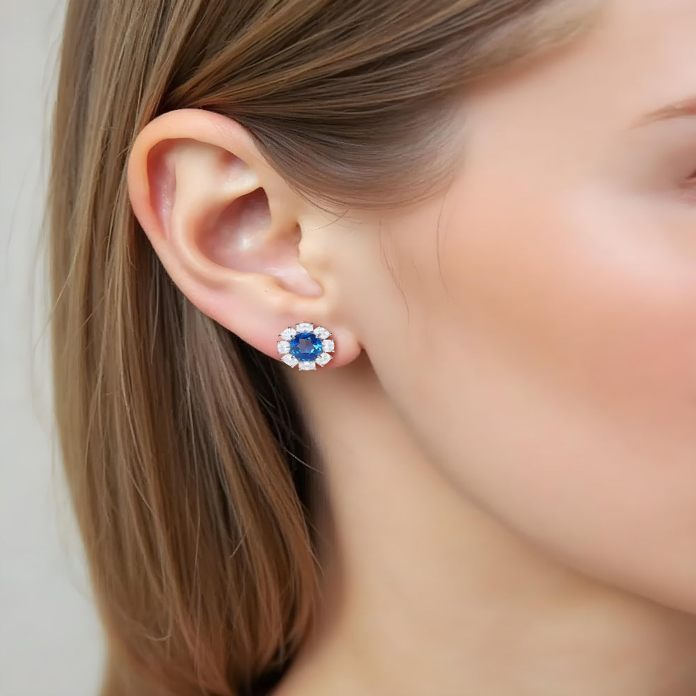 Woman wearing sapphire and diamond halo stud earrings ¨C elegant gemstone jewellery by Aeterna Jewellery UK