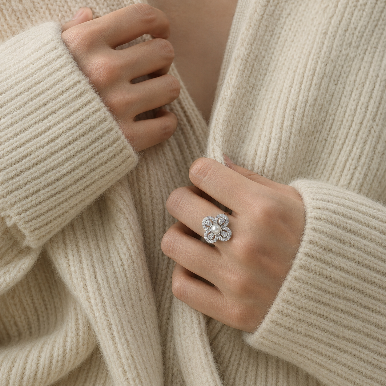 Aurelia Pearl Clover Statement Ring worn with a cream knit sweater