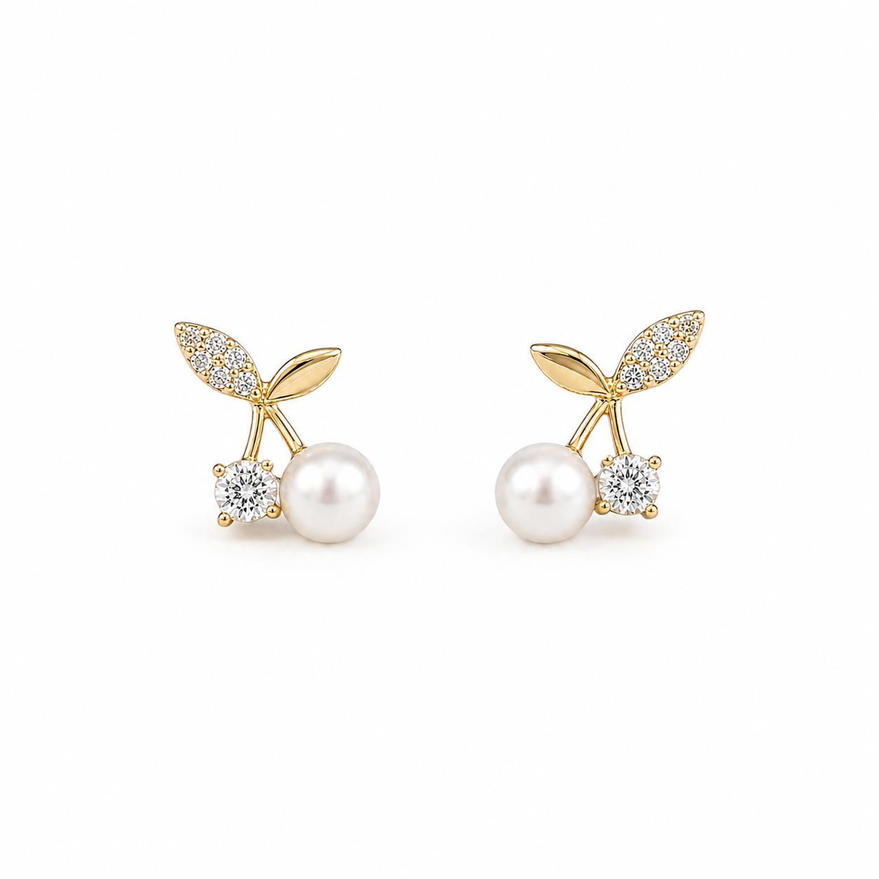 Gold pearl stud earrings on white background