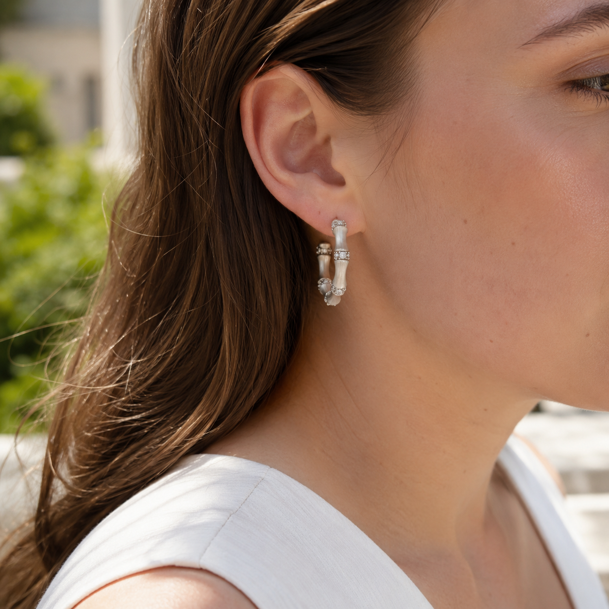 Close-up of model wearing silver bamboo hoop earrings
