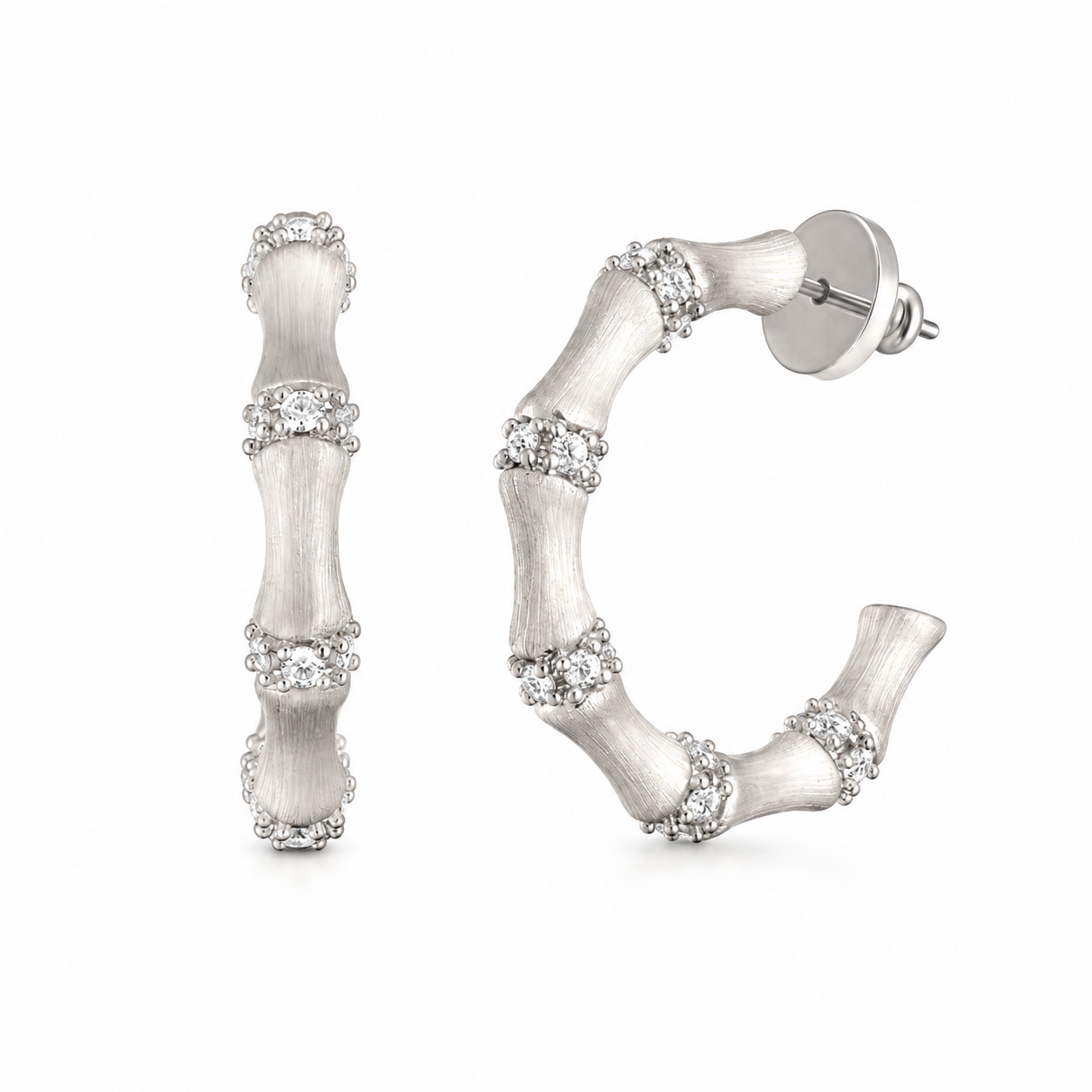 Silver bamboo hoop earrings with clear stone accents on white background