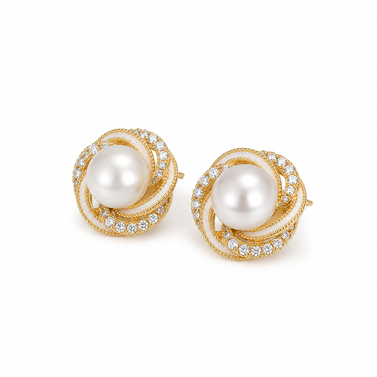 Gold pearl stud earrings on white background