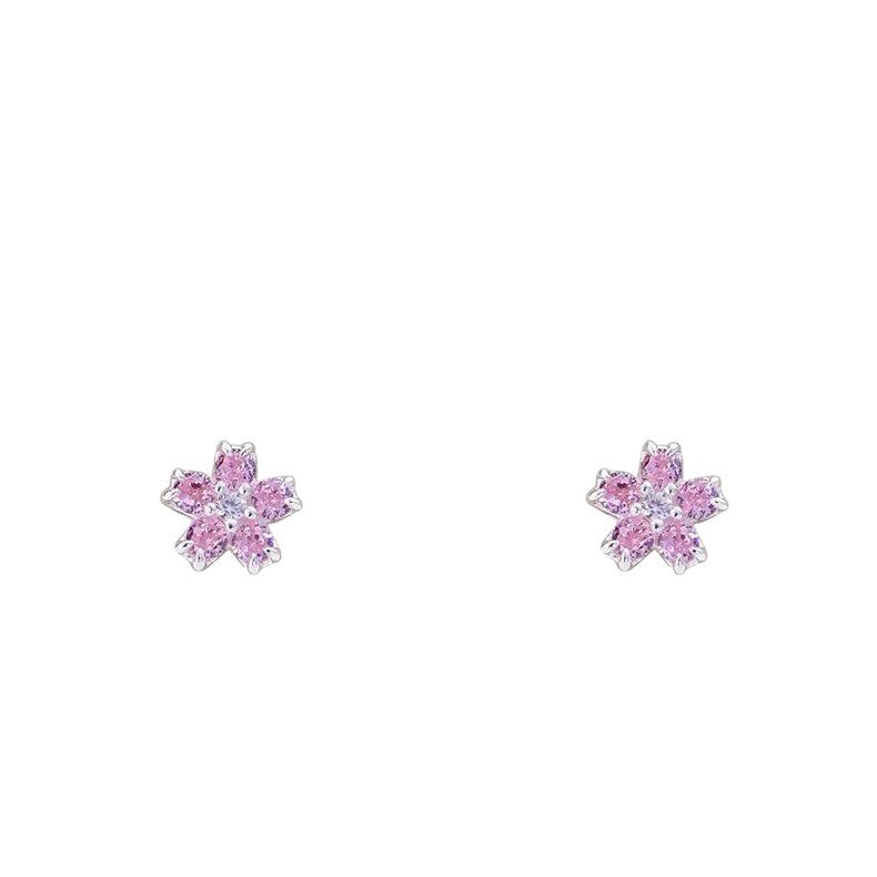 Pair of silver-tone pink cubic zirconia flower stud earrings on a white background