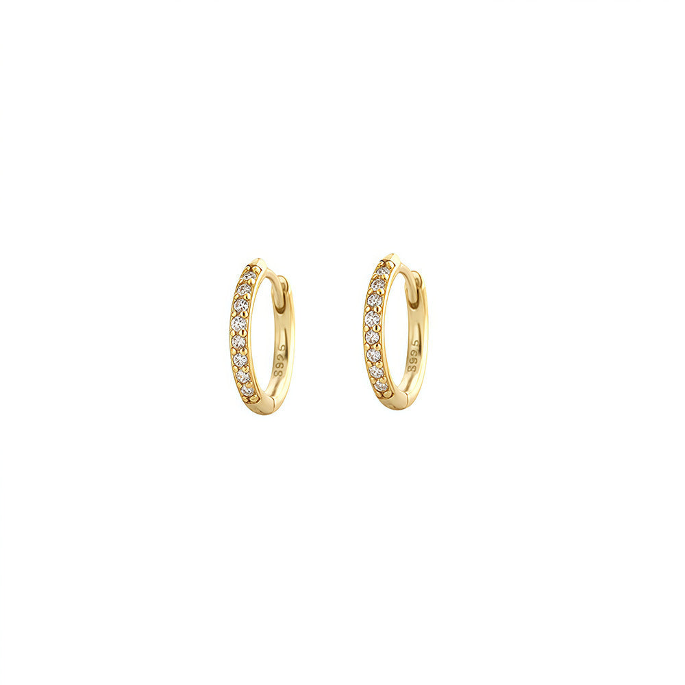 Pair of gold-plated 8mm pavé huggie earrings on a white background