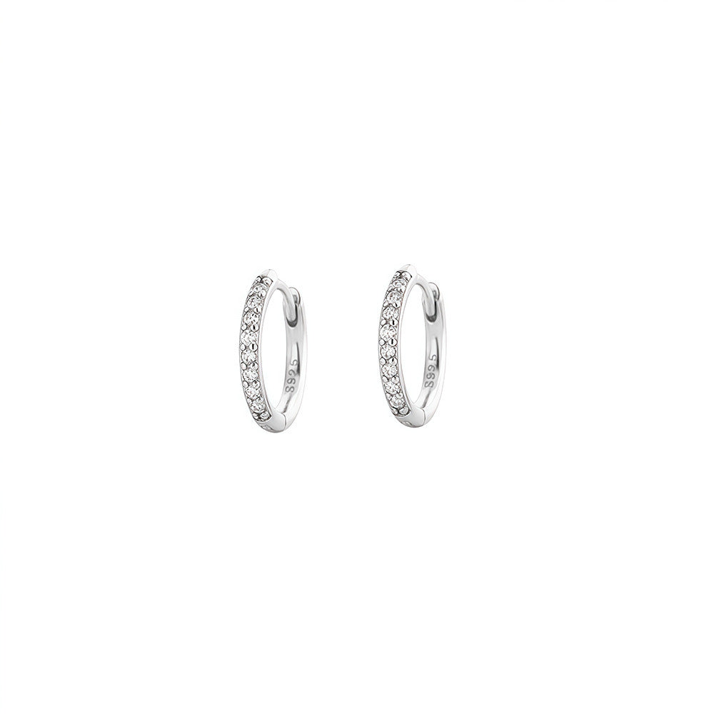 Pair of silver 8mm cubic zirconia huggie earrings on a white background