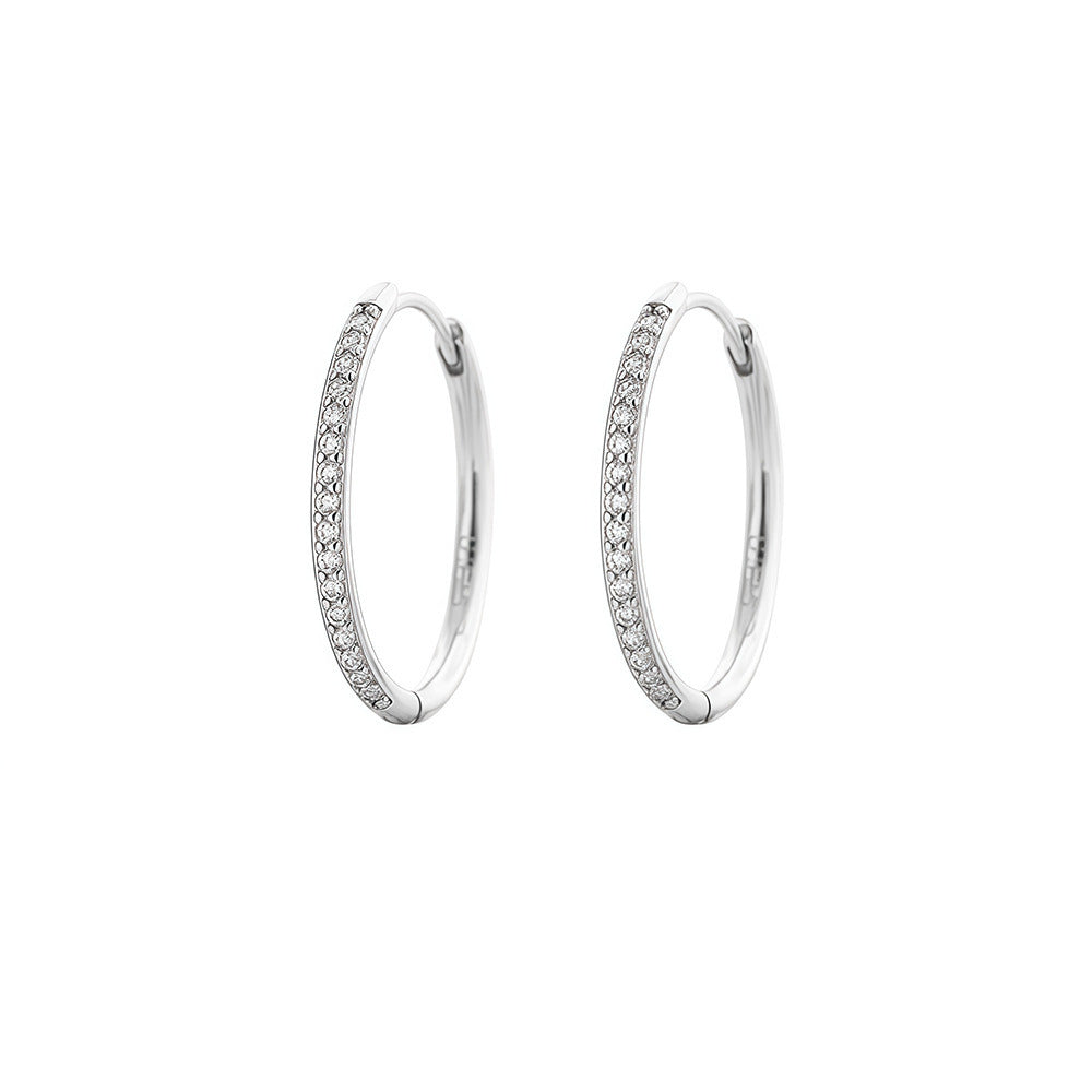 Pair of silver 16mm cubic zirconia hoop earrings on a white background