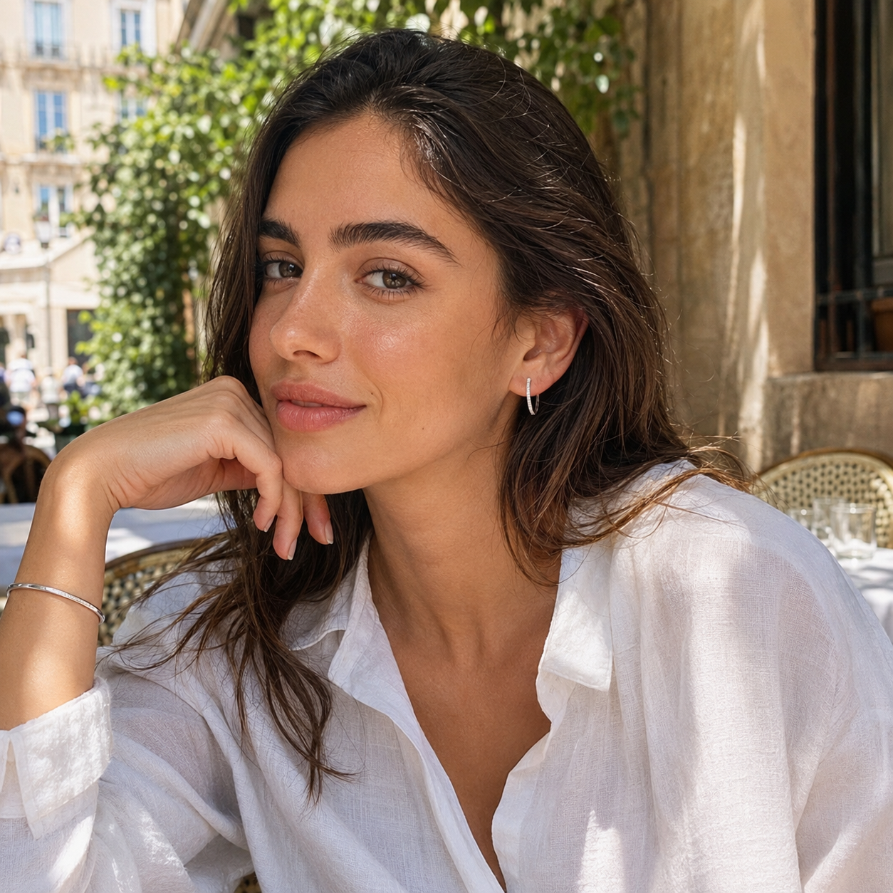 Model wearing silver pavé hoop earrings with a casual white summer outfit