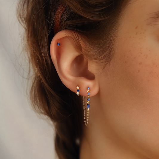 Model wearing a blue cubic zirconia earring stack