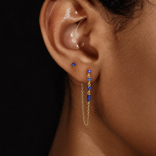 Close-up of model wearing a blue cubic zirconia chain drop earring