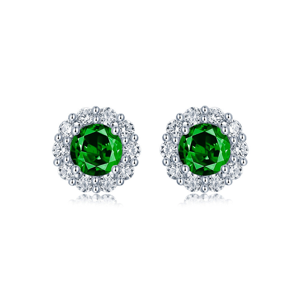Elegant emerald and diamond halo stud earrings in 925 sterling silver, fine jewelry by Aeterna Jewelry, white background product photo
