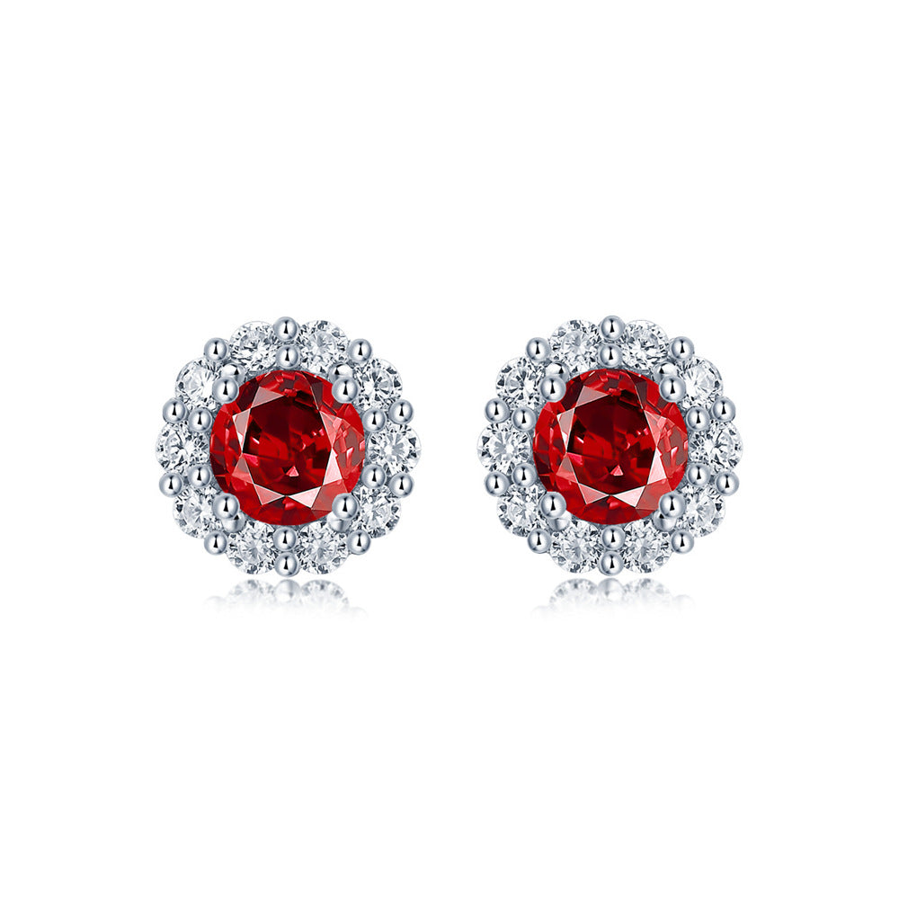 Elegant ruby and diamond halo stud earrings in sterling silver, fine jewelry by Aeterna Jewelry, product photography on white background