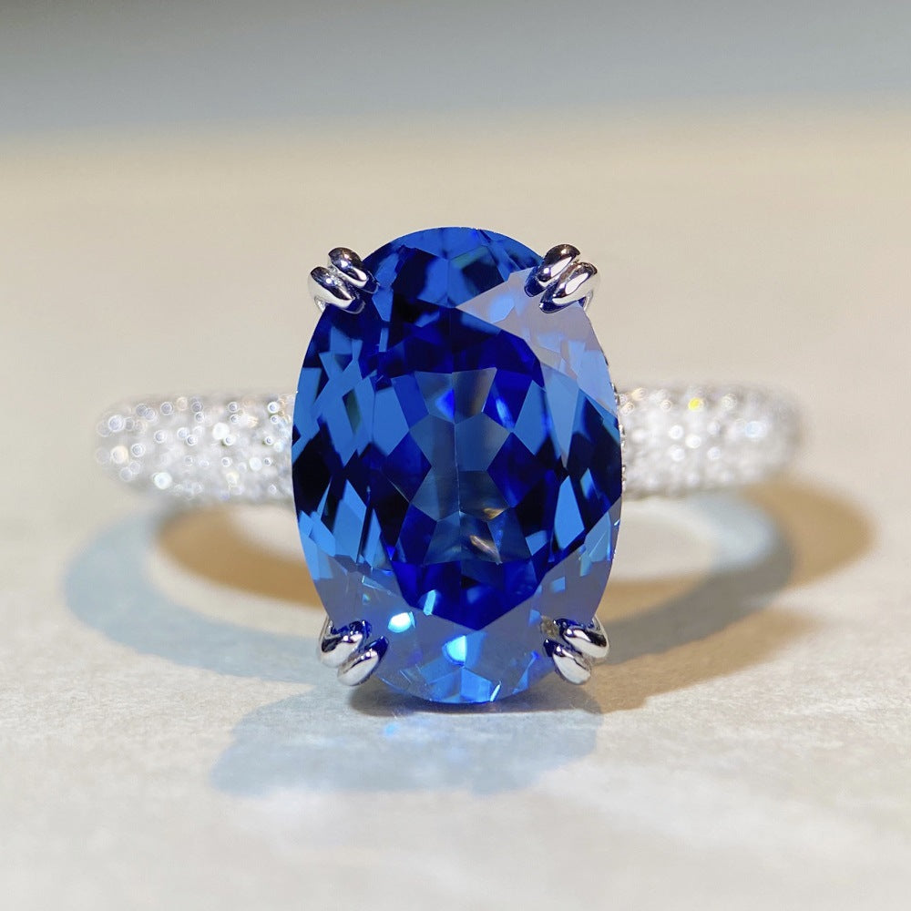 Close-up of oval-cut blue sapphire ring with faceted brilliance