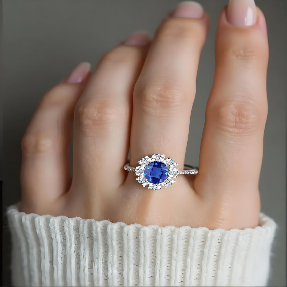 Elegant model wearing Aeterna Jewelry blue sapphire halo ring, showing vivid royal blue brilliance on hand