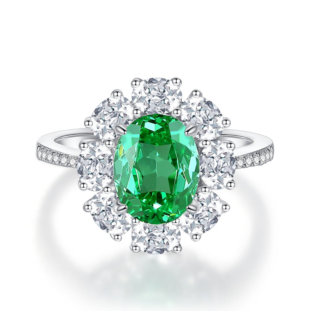 Aeterna Jewelry oval Paraiba green tourmaline halo ring in sterling silver surrounded by white gemstones on white background