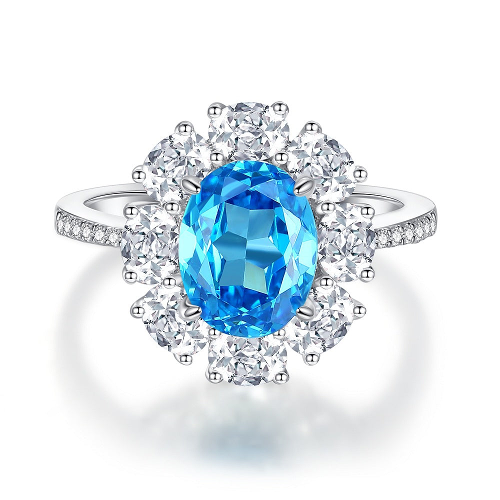 Aeterna Jewelry oval aquamarine floral halo ring in sterling silver surrounded by white gemstones on white background