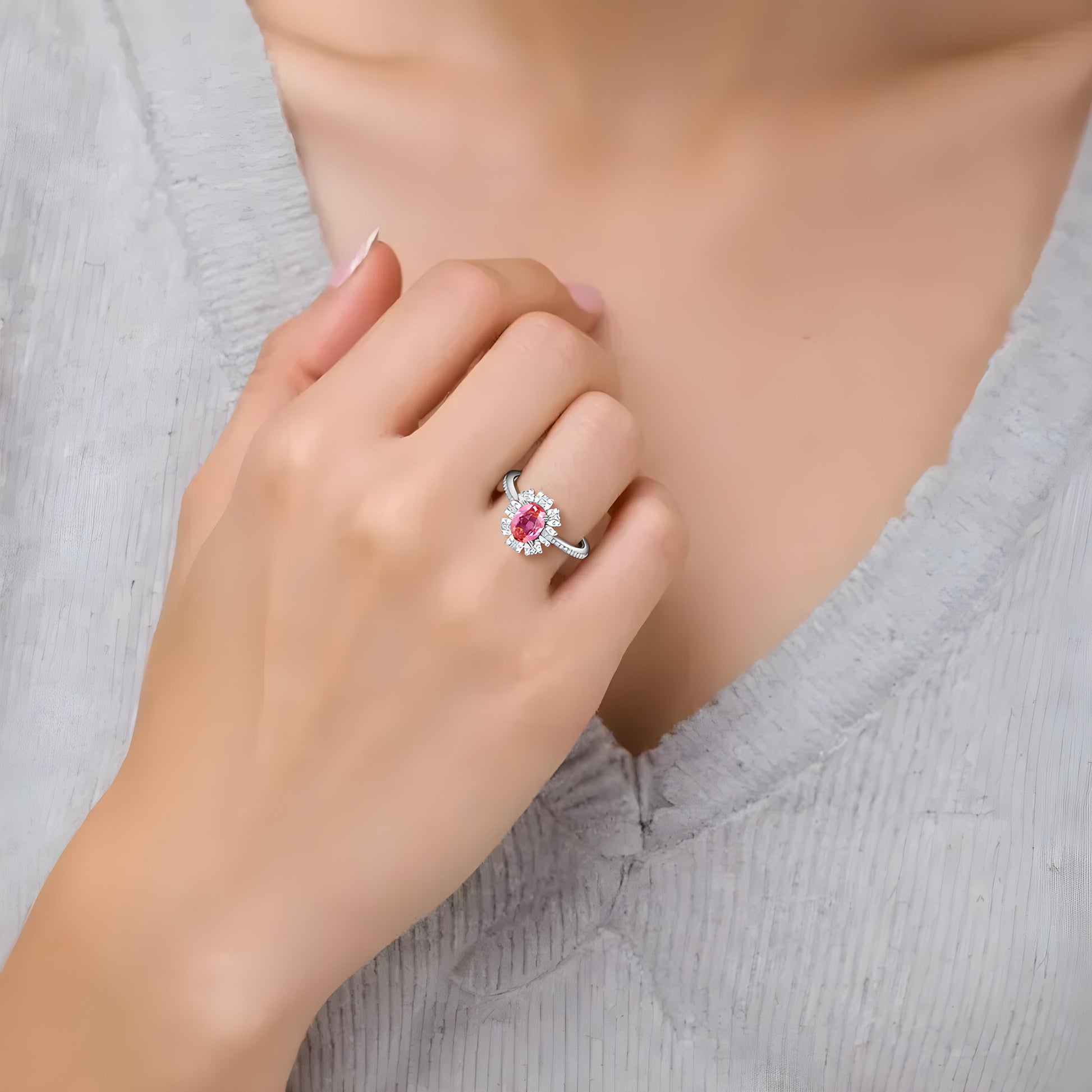 Elegant model wearing Aeterna Jewelry Padparadscha sapphire halo ring, showing soft pink-orange brilliance