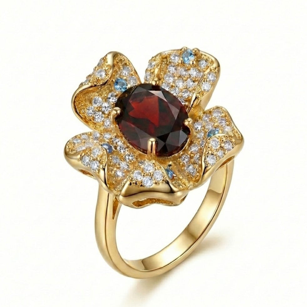 Gold garnet flower ring featuring pav¨¦ diamonds and floral design on a white background