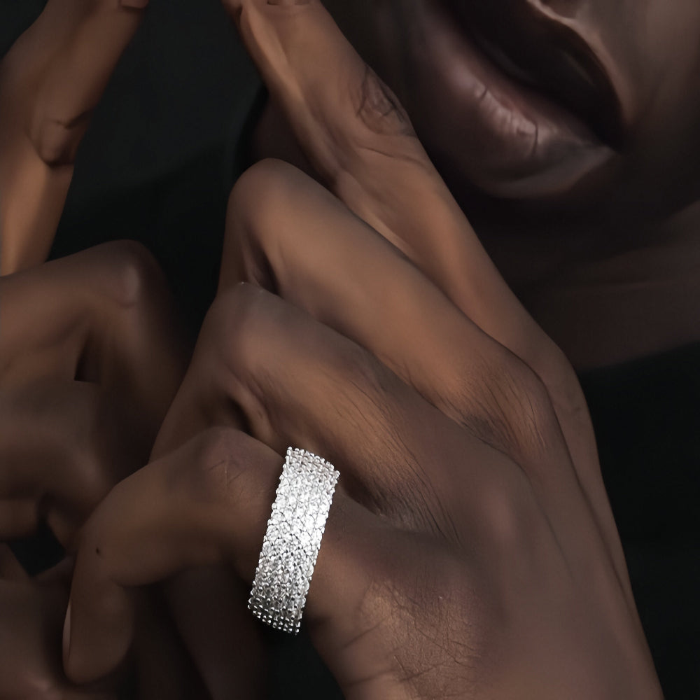 Aeterna Jewelry pav¨¦ diamond band ring worn by model¡¯s hand in close-up view