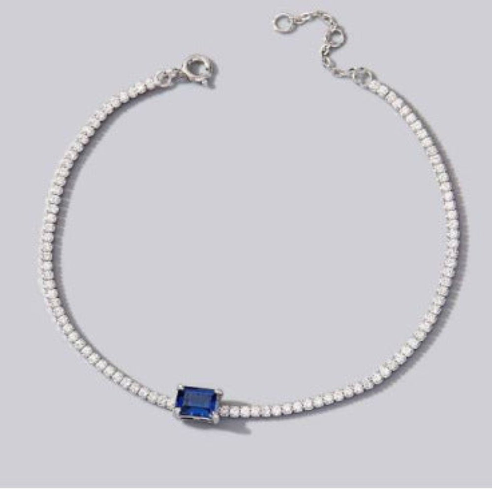 Aeterna Jewelry sapphire solitaire tennis bracelet on soft gray background