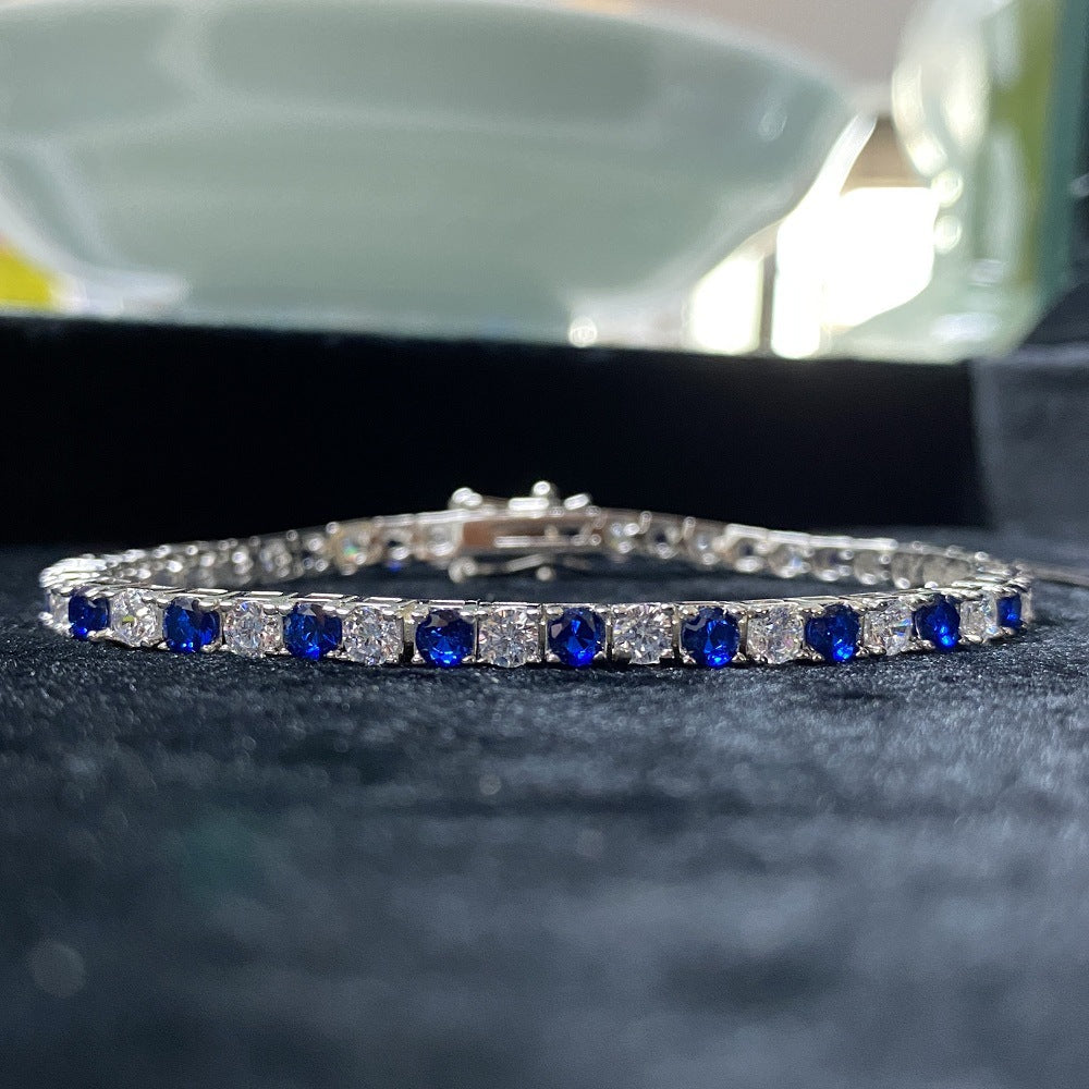 Aeterna Jewelry blue and white alternating tennis bracelet on black velvet background