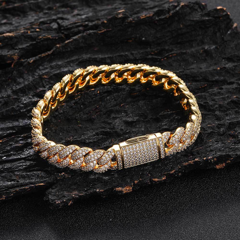 Gold cuban link bracelet by Aeterna Jewelry on dark textured surface