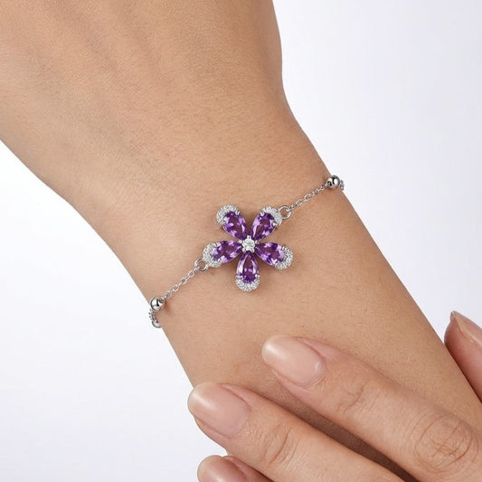 Amethyst flower ring worn on hand in sterling silver