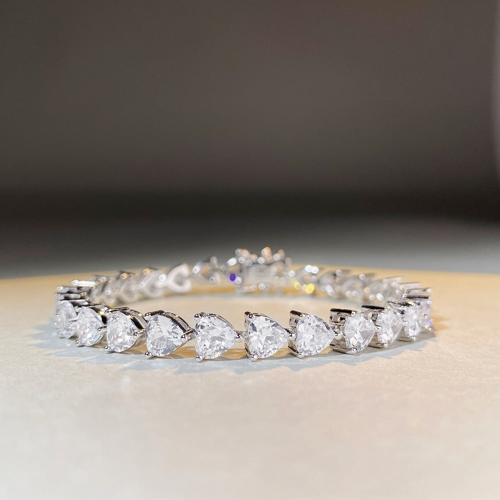 Heart cut tennis bracelet photographed under soft light by Aeterna Jewelry