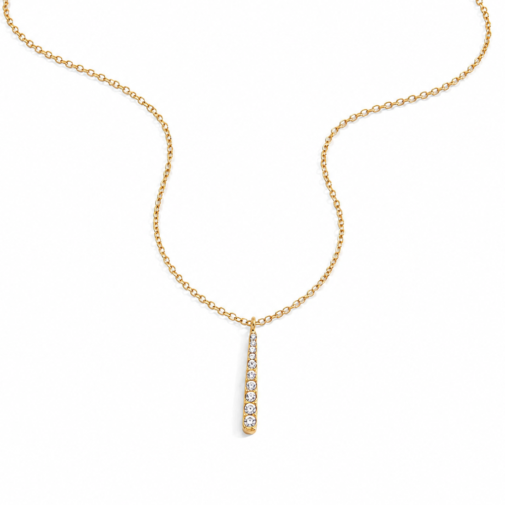 Liora gold pavé bar necklace with cubic zirconia pendant on a white background