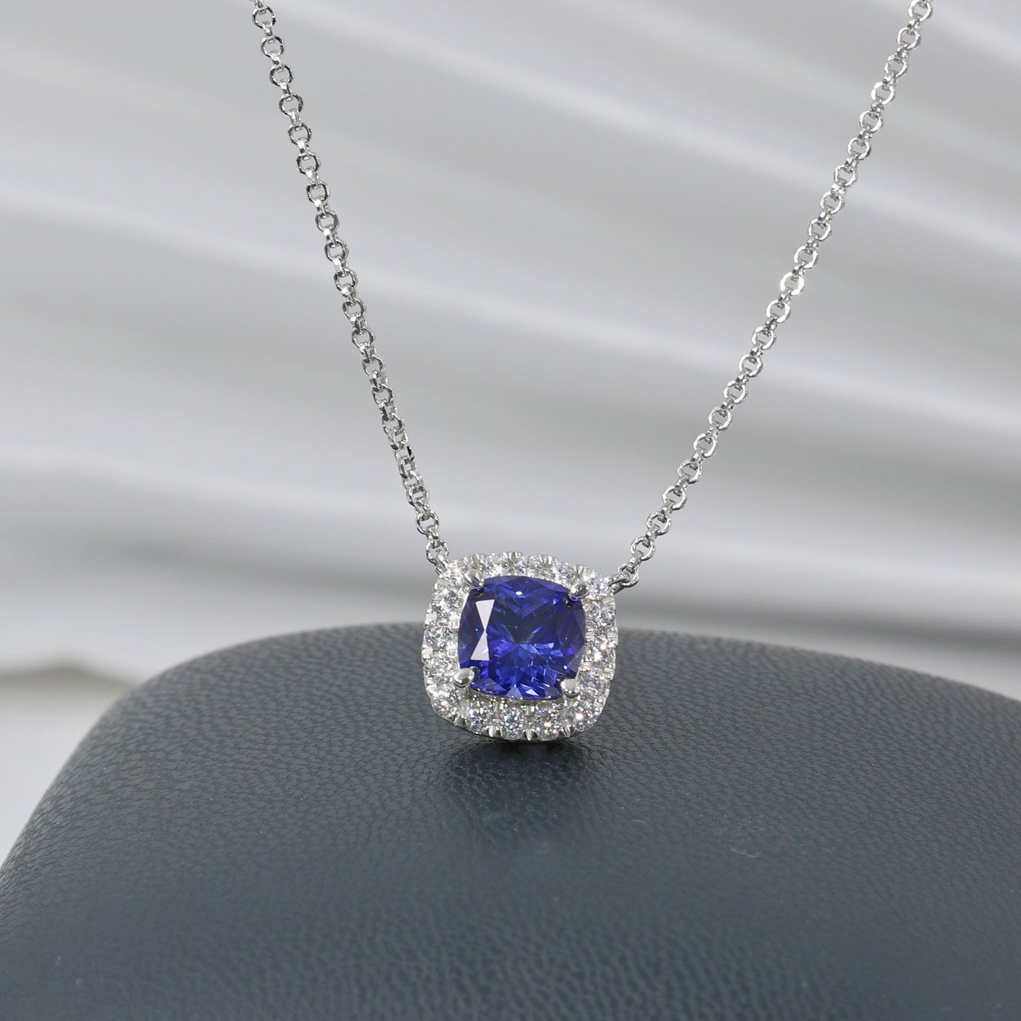 Aeterna Jewelry 1.9ct cushion-cut blue sapphire halo pendant necklace on white background