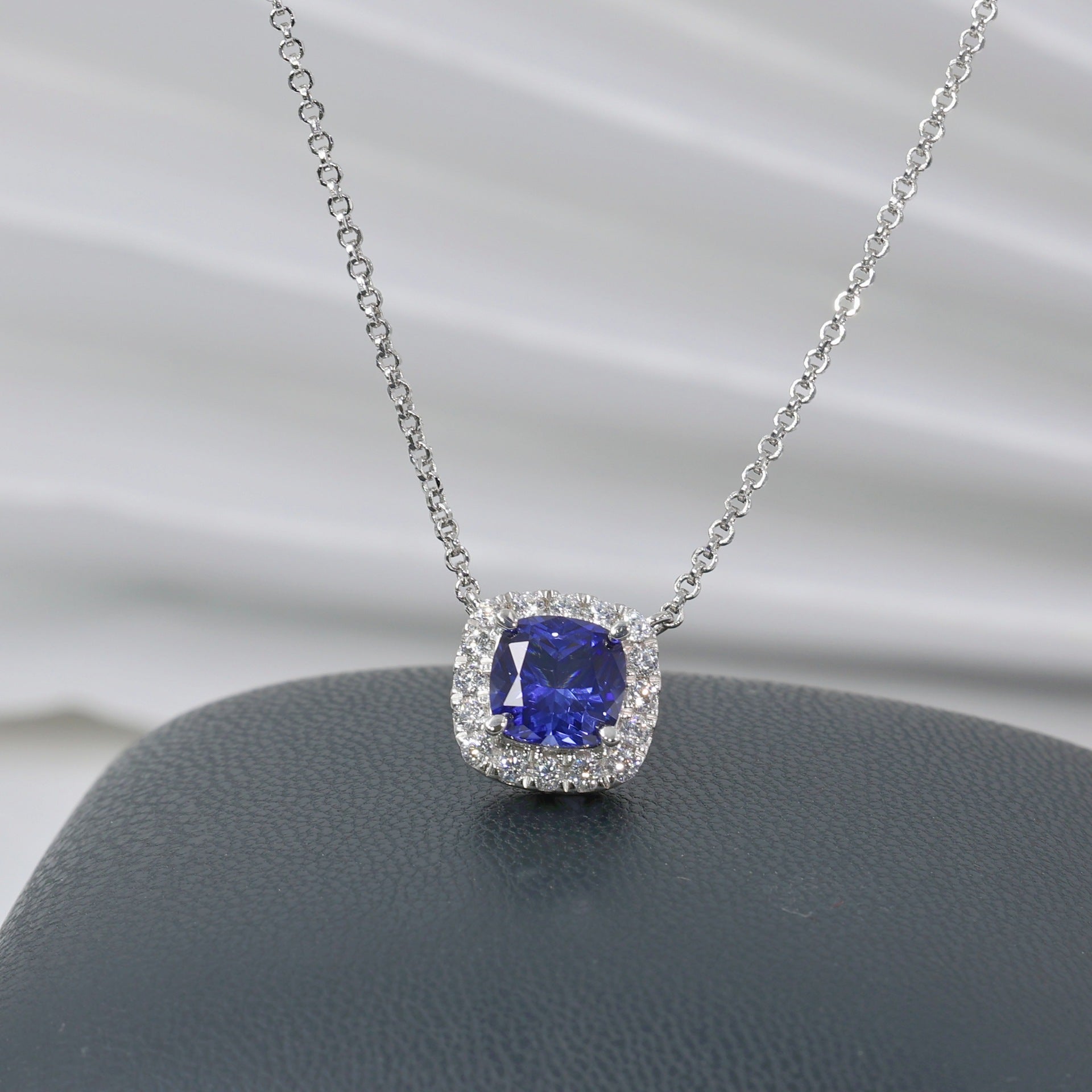 Aeterna Jewelry 1.9ct cushion-cut blue sapphire halo pendant necklace on white background