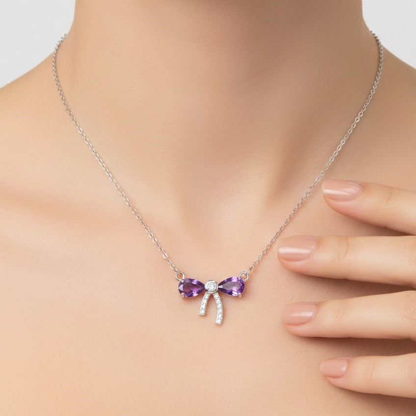 Amethyst bow necklace worn on model neck in sterling silver