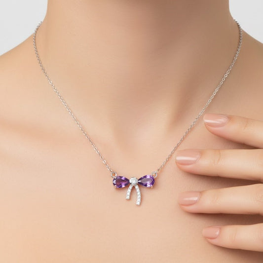 Amethyst bow necklace worn on model neck in sterling silver