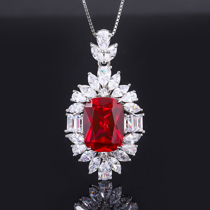 Aeterna Jewelry oval-cut red ruby halo pendant necklace on black background