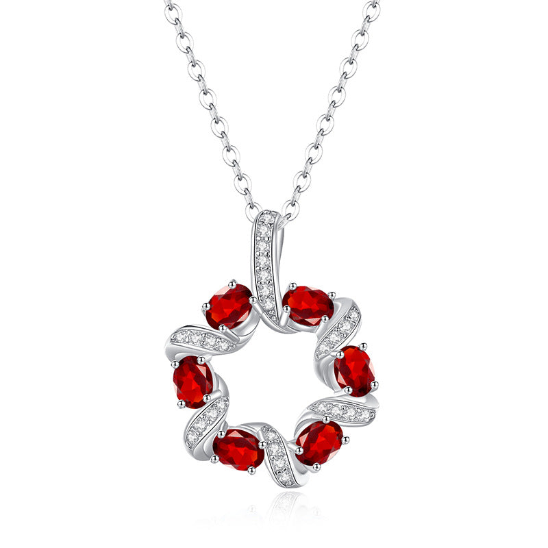 Garnet birthstone circle pendant necklace in sterling silver on white background