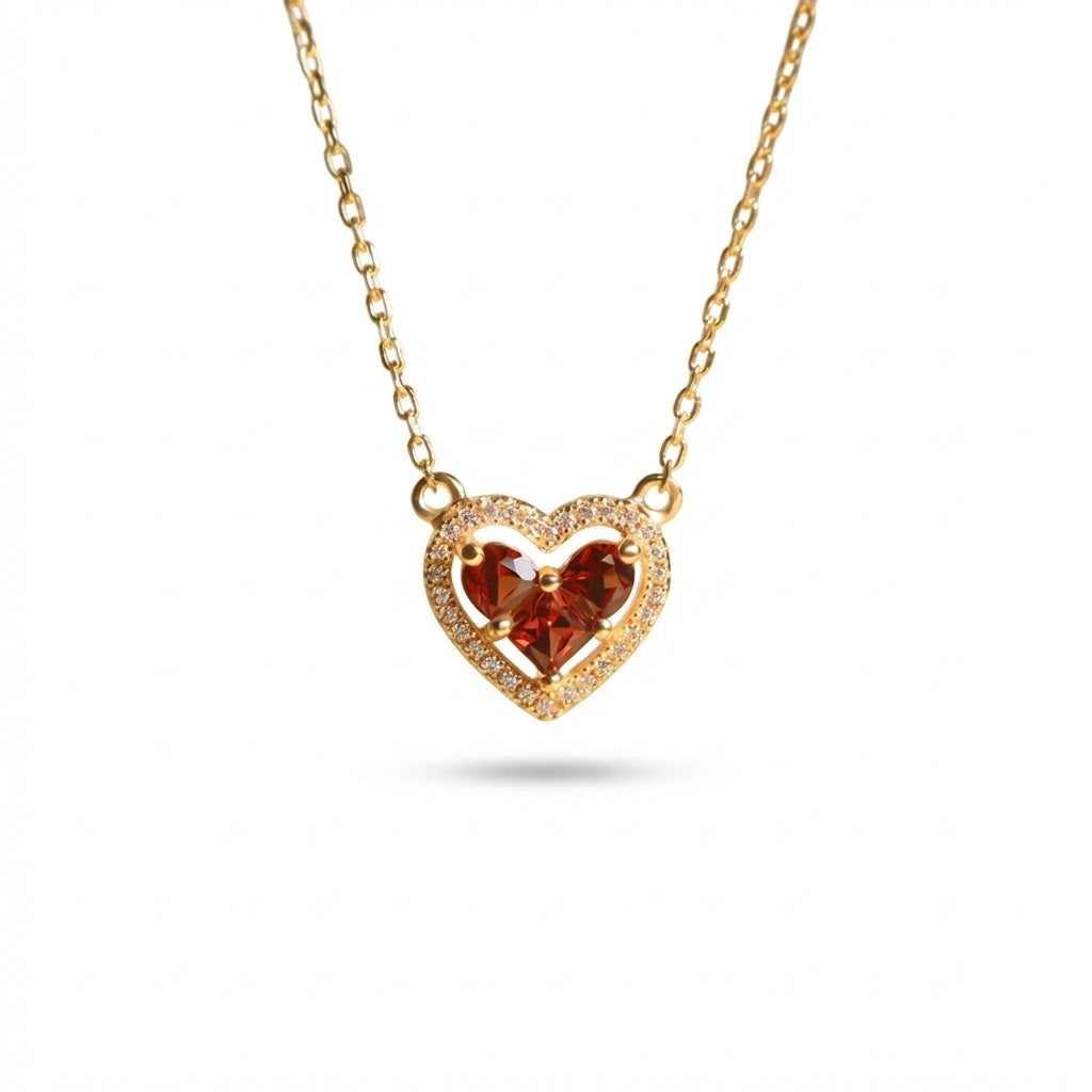 Heart garnet birthstone necklace in gold-plated 925 sterling silver on white background